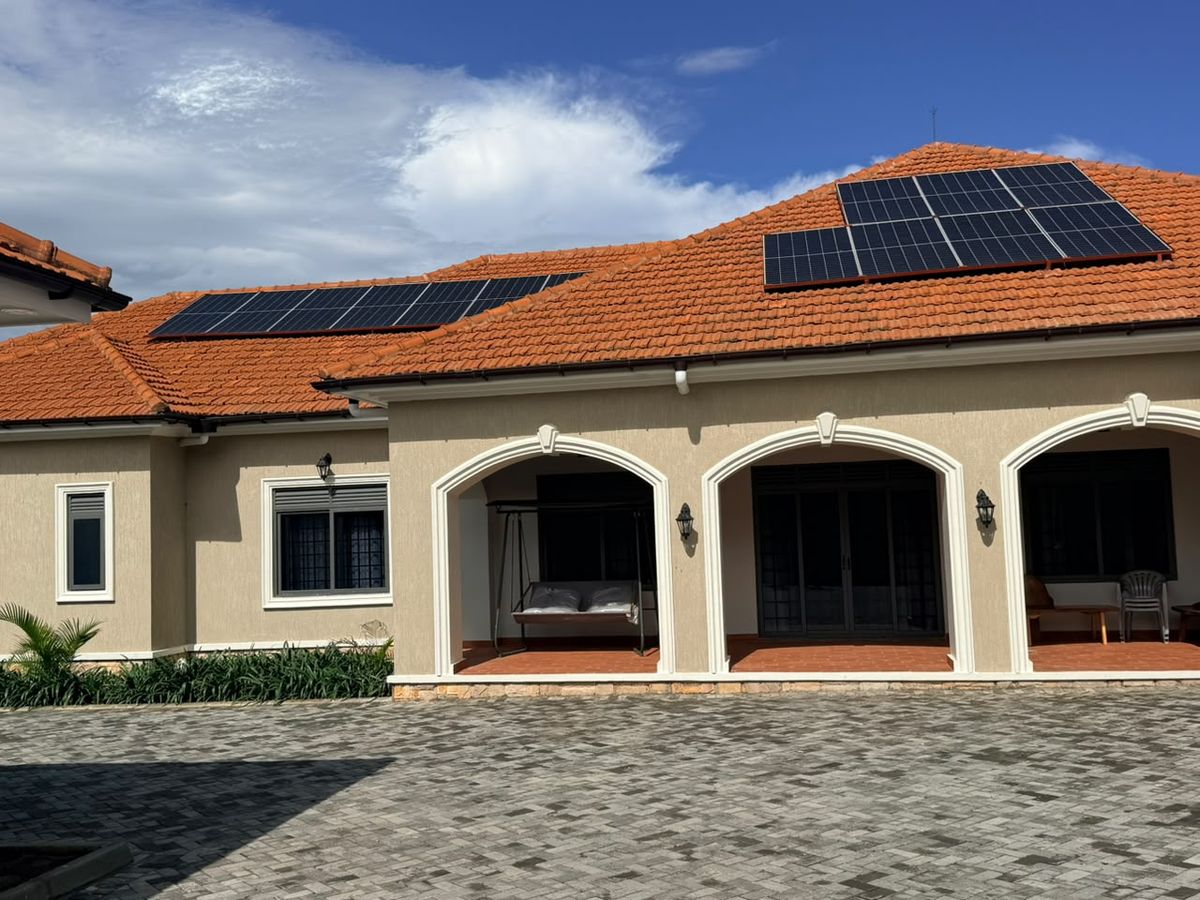 Single-storey home with orange tiled roof and two rooftop solar arrays